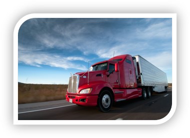 An image of a large transport truck driving on a highway.