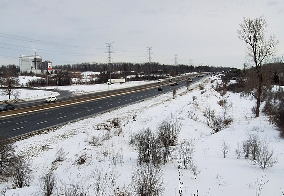 Winter view of Highway 401 with vehicles traveling through a snow-covered landscape.
